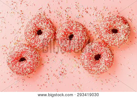Five Coral Donuts Lying In A Line.