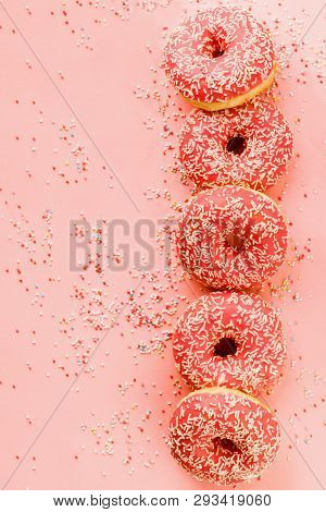 Five Coral Donuts Lying In A Line.