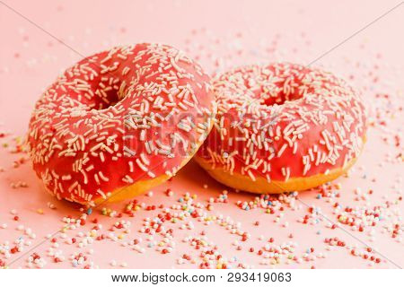 Two Coral Donuts. Donuts Decorated With Icing