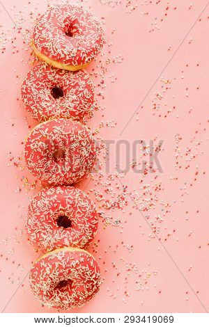 Five Coral Donuts Lying In A Line.