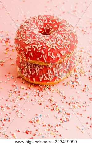 Two Coral Donuts Standing In A Line. Donuts Decorated With Icing