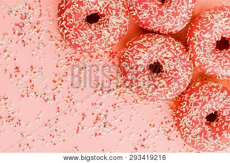 Five Coral Donuts Lying In A Corner.