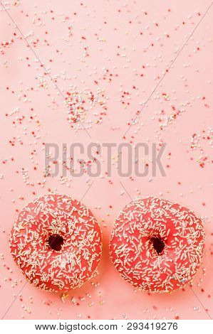 Two Coral Donuts. Donuts With Icing On Pink Background.