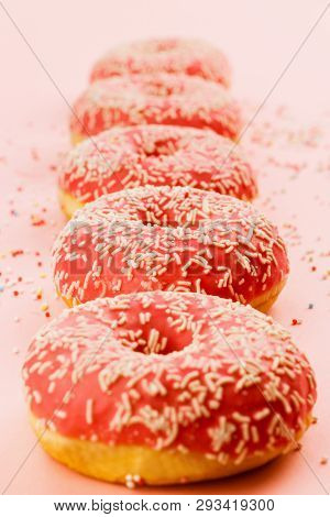 Five Coral Donuts Standing In A Line. Donuts With Icing