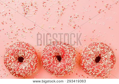 Three Coral Donuts. Donuts With Icing On Pink Background.