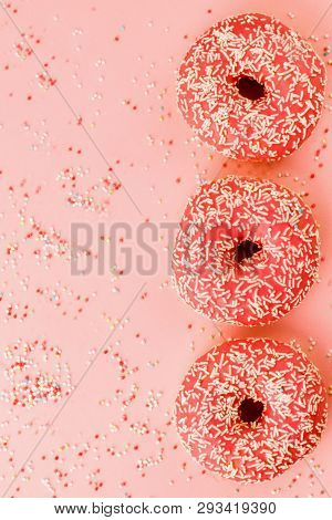 Three Coral Donuts. Donuts With Icing On Pink Background.