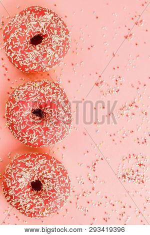 Three Coral Donuts. Donuts With Icing On Pink Background.