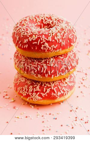 Three Coral Donuts Standing In A Line. Donuts With Icing