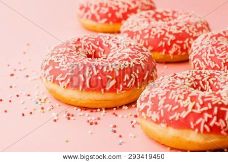 Coral Donuts. Donuts Decorated With Icing On Pink Background.