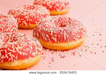 Coral Donuts. Donuts Decorated With Icing On Pink Background.