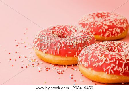 Coral Donuts. Donuts Decorated With Icing On Pink Background.