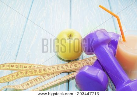 The Concept Of A Healthy Diet. Small Dumbbells, Juice. Bananas. Oranges. Apples. Healthy Lifestyle. 