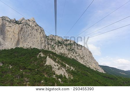 Ropes Of Tourist Suspended Transport Rise To The Top Of The High Crimean Mountain Ai-petri. Rocks Ov