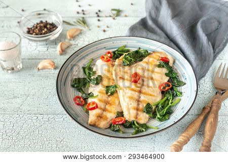 Grilled Sea Bream Fish Fillet With Spinach And Chili Pepper
