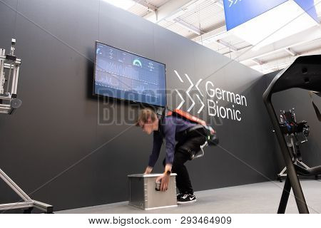 Hannover , Germany - April 02 2019 : German Bionic Presents First Robot Exoskeleton For The Industri