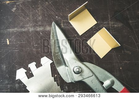 Tinsmith tools on the working table in the factory