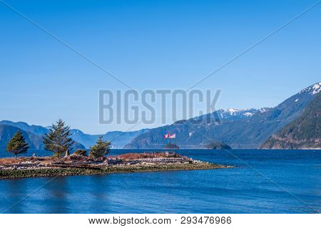 Fantastic view over ocean, snow mountain and rocks at Sechelt inlet in Vancouver, Canada.
