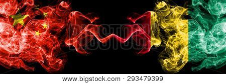 China Vs Guinea, Guinean Smoke Flags Placed Side By Side. Thick Colored Silky Smoke Flags Of Chinese
