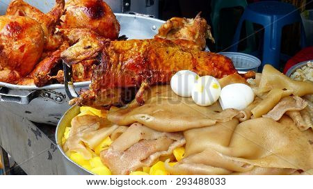 Roasted Cuy Or Guinea Pig, Roasted Whole Chickens, Big Metal Bowl With Cooked Potatos, Pigs Skin And