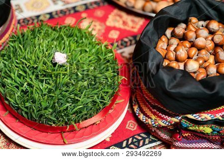 Semeni With A White Rose In The Middle And A Bag Of Nuts On A Tablecloth With National Patterns And 