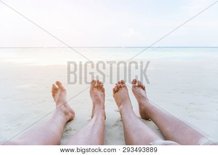Couple Relaxing In Summer Holiday On Beach