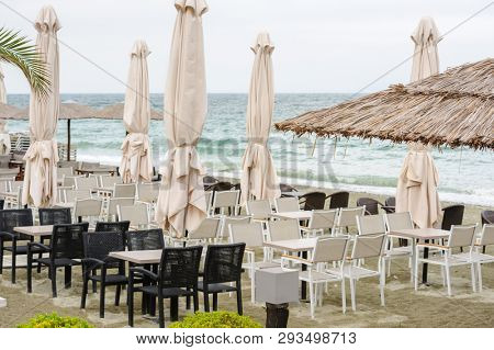 Empty beach outdoor cafe at low season with bad weather with no people. Leptokaria, Makedonia, Greece