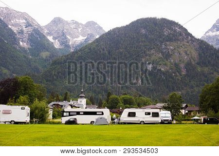 Autocampers Are On Campground Parking In The Alpine Mountains