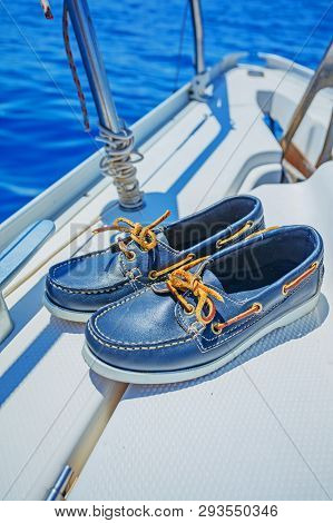 A Pair Of Topsider On White Yacht Deck. Yachting