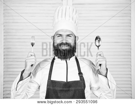 Chef Happy Smiling Face Hold Spoon And Fork. Man Handsome With Beard Holds Kitchenware On White Back
