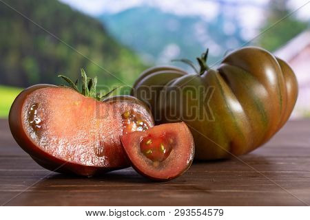 Group Of One Whole One Half One Slice Of Fresh Tomato Primora With Country Nature In Background