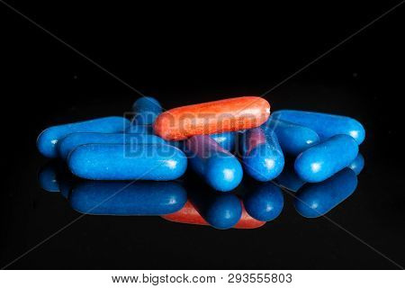 Lot Of Whole Blue And One Red Sweet Licorice Comfit Isolated On Black Glass