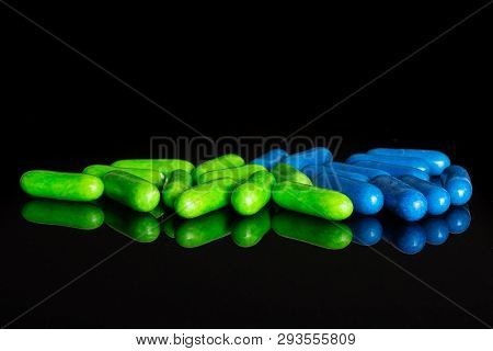 Lot Of Whole Green And Blue Sweet Licorice Comfit Isolated On Black Glass