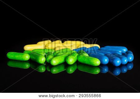 Lot Of Whole Green Blue And Yellow Sweet Licorice Comfit Isolated On Black Glass