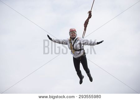 Belarus, Gomel, March 08, 2019. Jumping From The Bridge To The Rope.ropejumping.an Elderly Woman Jum