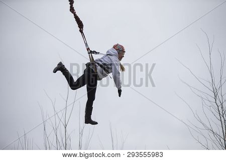Belarus, Gomel, March 08, 2019. Jumping From The Bridge To The Rope.ropejumping.an Elderly Woman Jum