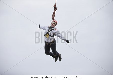 Belarus, Gomel, March 08, 2019. Jumping From The Bridge To The Rope.ropejumping.an Elderly Woman Jum