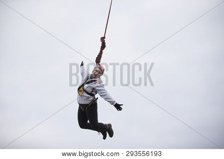 Belarus, Gomel, March 08, 2019. Jumping From The Bridge To The Rope.ropejumping.an Elderly Woman Jum
