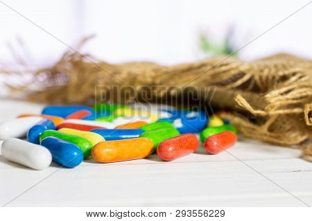 Lot Of Whole Sweet Licorice Comfit On Jute Cloth With Flowers In A White Kitchen