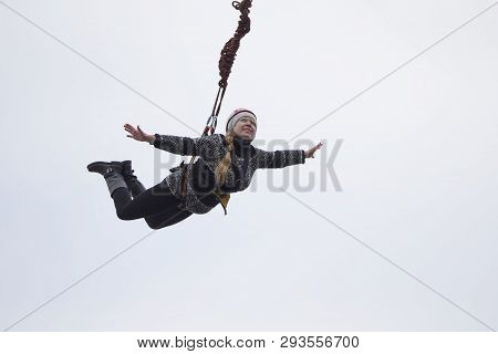 Belarus, Gomel, March 08, 2019. Jumping From The Bridge To The Rope.ropejumping.an Elderly Woman Jum