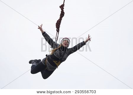 Belarus, Gomel, March 08, 2019. Jumping From The Bridge To The Rope.ropejumping.an Elderly Woman Jum