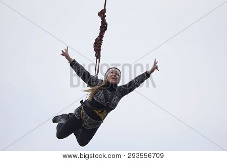 Belarus, Gomel, March 08, 2019. Jumping From The Bridge To The Rope.ropejumping.an Elderly Woman Jum
