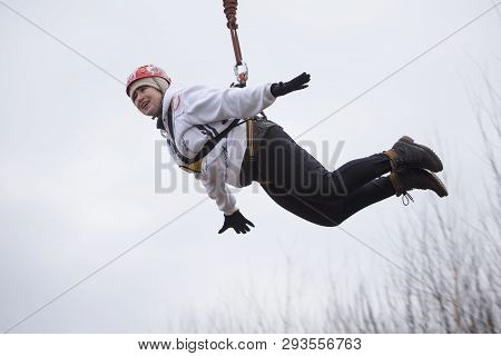 Belarus, Gomel, March 08, 2019. Jumping From The Bridge To The Rope.ropejumping.an Elderly Woman Jum