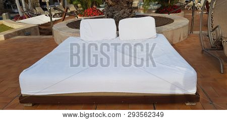 Close Up Of A Comfortable Bed For Tan And Rest With White Matress Near A Rocking Chair Stay Empty In