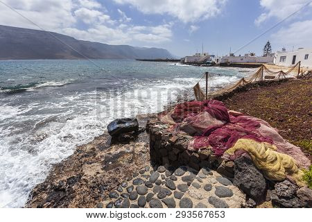 Fishing Nets Drying At The Coast Of Village Caleta De Sebo On The Island La Graciosa Of Lanzarote