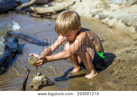 Kid Playing In The Sand On The Summer Beach