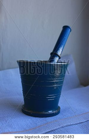 Ancient Blue Metal Mortar With Pestle On Linen Background. Old Home Kitchen Appliances For Grinding 