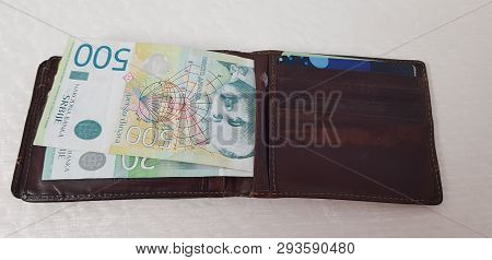 Brown Leather Wallet With Credit Cards And Serbian Paper Money Lay On White Table