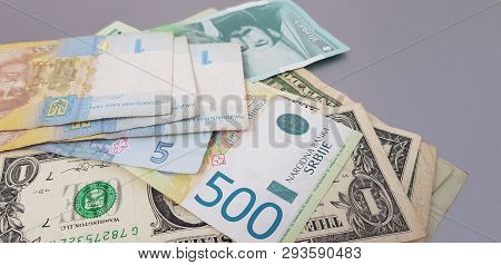 Close Up Of Banknotes Of Hryvnia Dynars And Dollars On Gray Background