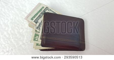 Brown Leather Wallet Full Of Various American Dollar Banknotes Isolated On White Background