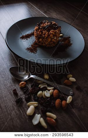 Anthill Cake With Chocolate And Coffee On A Dark Background. Dessert With Nuts And Raisins. Bolo For